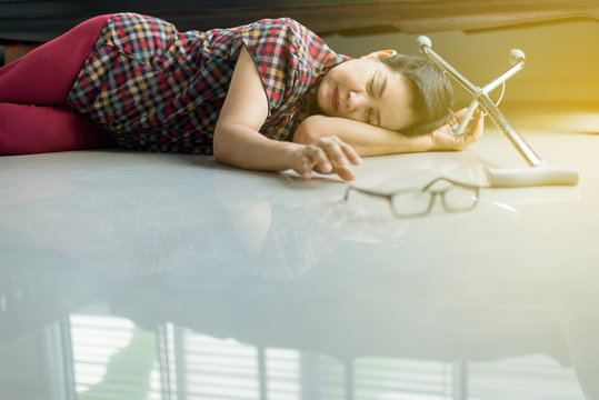 Senior asian female suffering with faint lying on floor after falling down at home