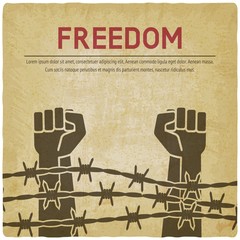 Fighting for freedom concept. Hands clenched into fist behind barbed wire vintage background © natbasil