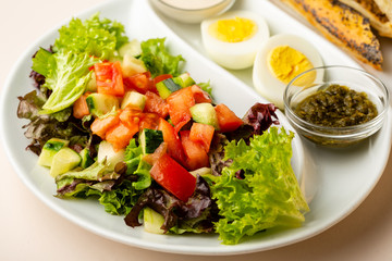 Healthy breakfast salad on white plate