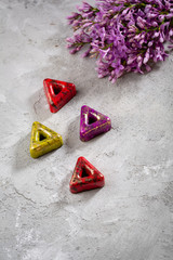 Chocolate bars on concrete, bonbons and flower