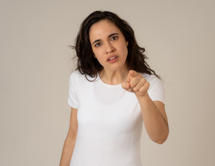 Portrait of beautiful young latin woman with angry and furious face. Human expressions and emotions