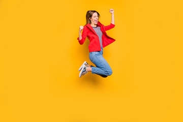 Fototapeta na wymiar Full length photo of cheerful person raising her fists screaming yeah isolated over yellow background