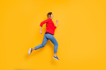Fototapeta na wymiar Full body profile side photo of cheerful lady running wearing red striped shirt jacket denim jeans isolated over yellow background