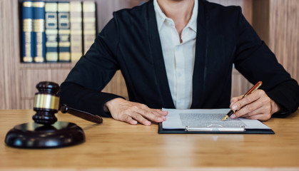 Judge gavel with Justice lawyers, Businesswoman in suit or lawyer working on a documents. Legal law, advice and justice concept
