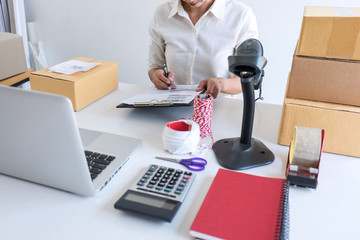 Small business owner delivery service and working packing box, business owner working checking order to confirm before sending customer in post office, Shipment Online Sales