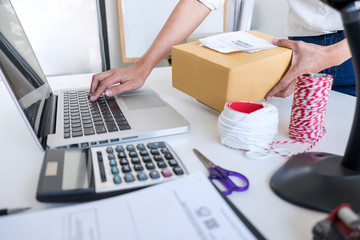 Young entrepreneur SME receive order client and working with packaging sort box delivery online market on purchase order and preparing package product, Small business parcel for shipment