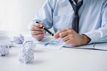 Senior businessman depressed and exhausted, businessman at his desk frustrated with problems with a pile of work and holding pen while sitting on office, Feeling sick and tired
