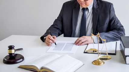 Judge gavel with Justice lawyers, Businessman in suit or lawyer working on a documents in courtroom. Legal law, advice and justice concept