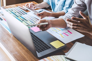 Team of Creative Web/Graphic Designer planning, drawing website ux app for mobile phone application and development template layout, process to developing prototype wireframe, User experience concept