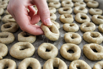 A woman putting cookie dough on a cookie sheet. Girl is cooking pastries. Cooking concept