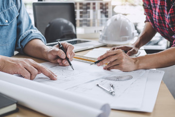 Construction and structure concept of Engineer or architect meeting for project working with partner and engineering tools on model building and blueprint in working site