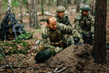 Soldiers on a halt. Preparing for the attack. Digging a trench.