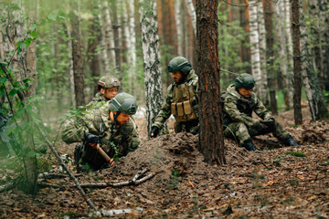 Soldiers on a halt. Preparing for the attack. Digging a trench.