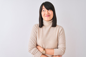 Fototapeta premium Young beautiful chinese woman wearing turtleneck sweater over isolated white background smiling looking to the side and staring away thinking.