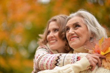 Fototapeta premium Close up portrait of smiling senior woman with adult daughter