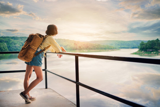Asian girl backpack on the park background, journey and traveling on holiday concept .