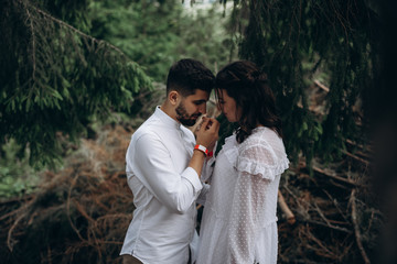 young man and woman are hugging in mountains