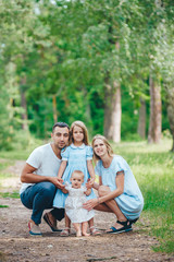 Fototapeta premium Happy family of four persons outdoors. Family portrait