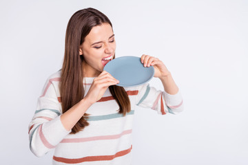 Pretty lady can't stand keeping to diet eating plate wear striped pullover isolated white background
