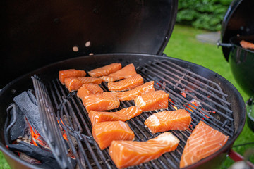 Delicious grilled pink wild salmon choped on smoking bbq cuisine