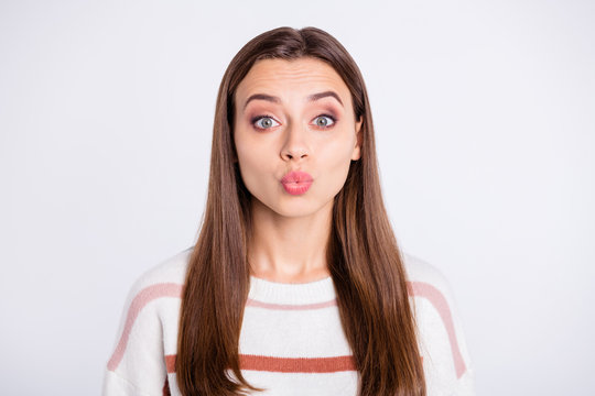 Photo of overjoyed lady sending air kiss to boyfriend wear striped pullover isolated white background