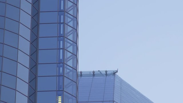 Glass Elevator Going Down the Glazed Facade of Skyscraper. Glass Curtain Facade Wall Background.