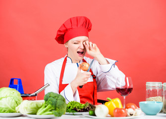 woman in cook hat crying because of onion. professional chef on red background. organic eating and vegetarian. Housewife. restaurant menu. Dieting. woman cooking healthy food by recipe. How to cook