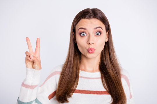 Photo of nice lady showing v-sign symbol sending air kiss wear striped pullover isolated white background