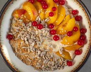Oatmeal with fruits, berries and cereals for Breakfast in a deep plate