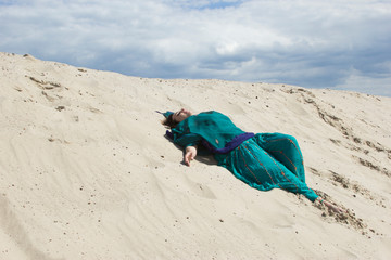 beautiful girl in a green sari in a sunny desert photo for text