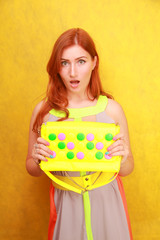 pretty redheaded girl in bright summer dress with yellow bright leather bag