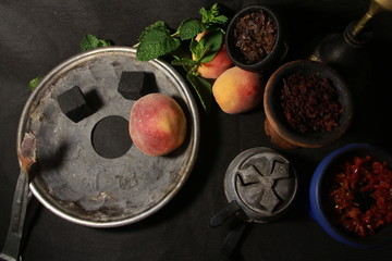 bowl with tobacco for hookah. berries on a black background
