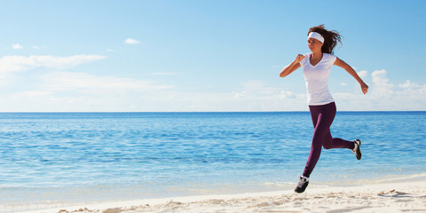 Young woman running on the beach. Summer concept. Healthy lifestyle. White sand, blue sky and crystal sea of tropical beach. Vacation at Paradise. Ocean beach relax, travel