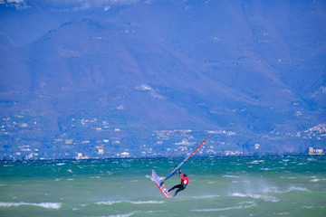 Windsurfer surfing the wind on waves In Garda Lake