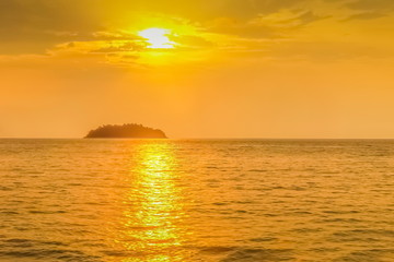 Fototapeta na wymiar view seaside evening of a small island with yellow sun light background, sunset at Kai Bae Beach, Koh Chang Island, Trat Province, Thailand.