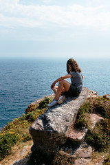 Beautiful woman looking at seascape in Brittany