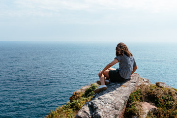 Naklejka na ściany i meble Beautiful woman looking at seascape in Brittany