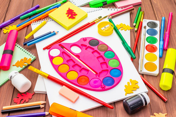 Back to school concept. School education supplies on brown wooden boards background