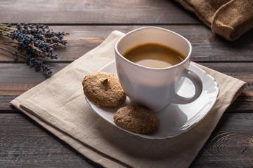 Cup of coffee on a linen napkin. Coffee beans and bag