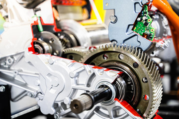 Engine sprocket And electronic circuit boards for control.Cross-section of a car gearbox. mechanics work in the garage.Shallow focus effect.