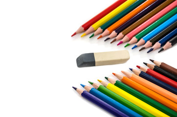 color pencils and eraser on a white background. Place for text.