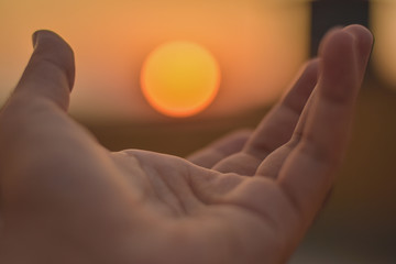 sun on male hand. Playing with sun