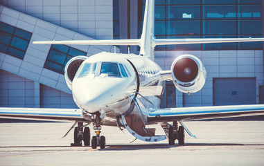 Luxury and shiny business jet standing at the airport. Luxury lifestyle and transportation by own...
