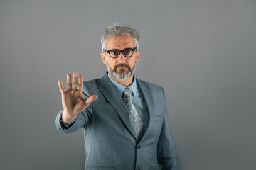 middle aged businessman showing open palm isolated