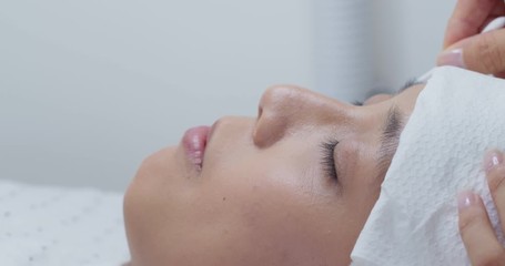 Asian woman with eyelash extension in beauty salon