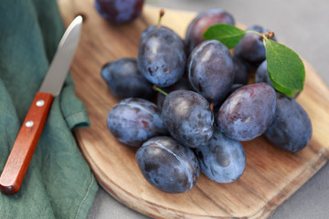 Farm plums on the concrete table. Significant antioxidant protection. Top view.