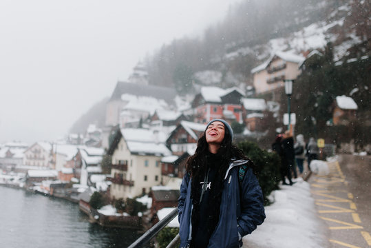 Young Woman Catching Snowflakes On Tongue In Austria, European Winter