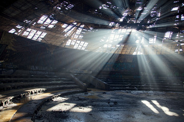 Rays of light through the roof of abandoned soviet building