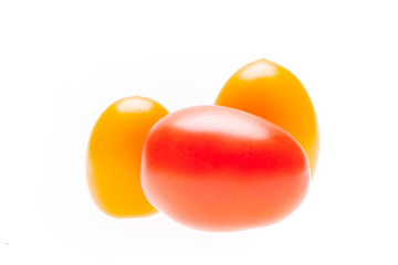 A group of fresh red and yellow cherry tomatoes isolated on the white