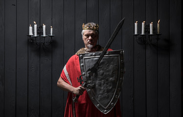 portrait of the old medieval king by candlelight